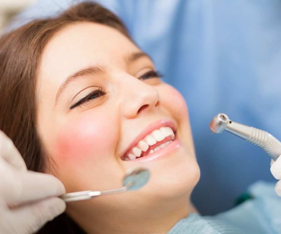 Woman receiving a dental treatment Woman receiving a dental treatment